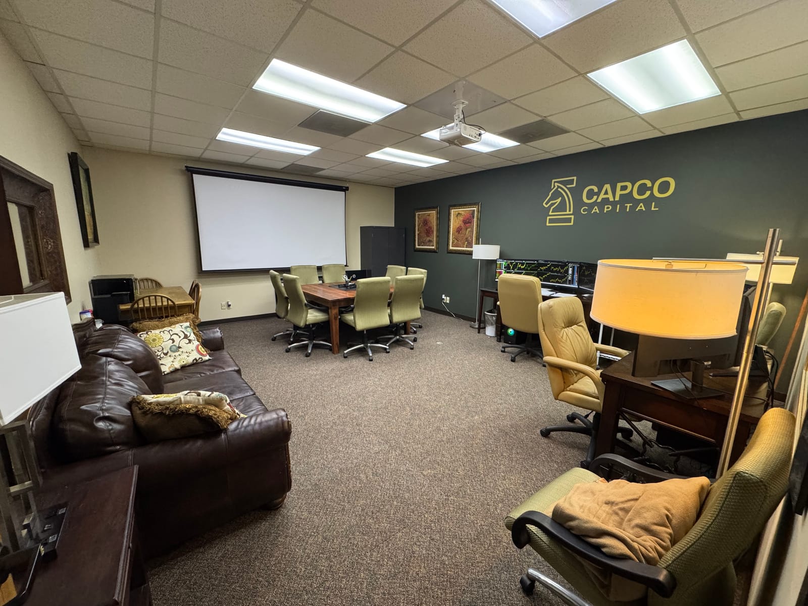 Inside the Commercial Capital Pro office with the gold knight logo on the wall